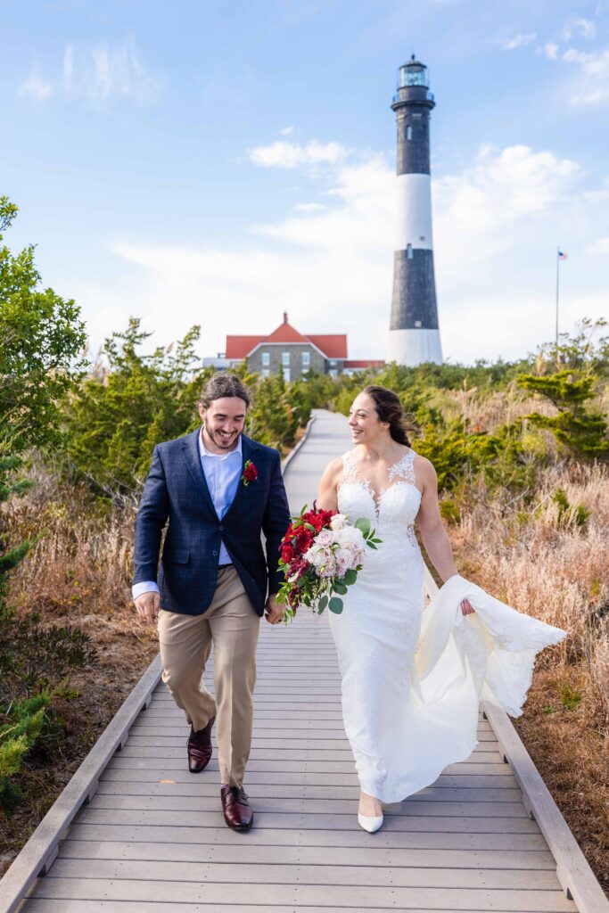 Bride and groom walk together after their elopement ceremony at a lighthouse.