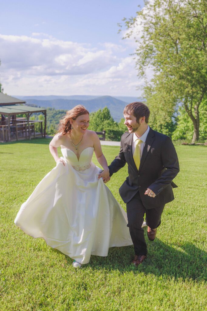 Bride and groom run together amongst the mountains of Virginia.